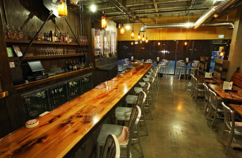 Industrial metal and high-gloss raw wood make for a striking design at Manito Taphouse. 